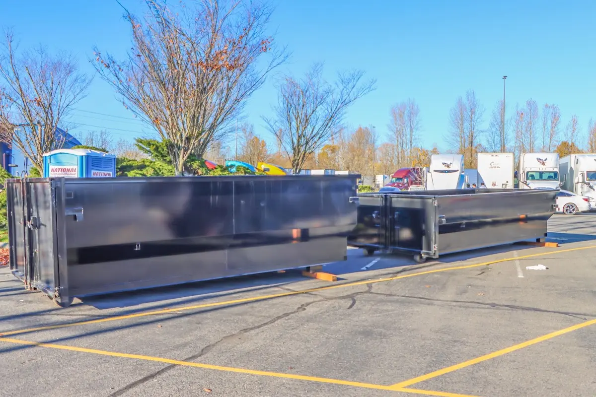 Professional dumpster rental service with roll-off container on residential driveway in Chaparral